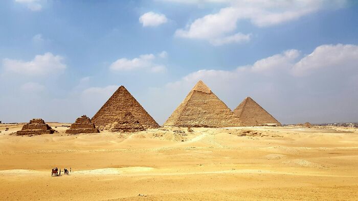 Pyramids of Giza under a blue sky, illustrating popular myths about iconic landmarks around the world.