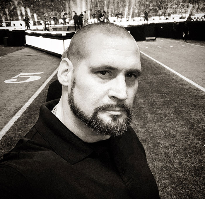 Security guard at stadium taking a selfie, related to fans furious with Chappell Roan after incident involving Jude Law's daughter. Security guard at stadium taking a selfie, related to fans furious with Chappell Roan after incident involving Jude Law's daughter.