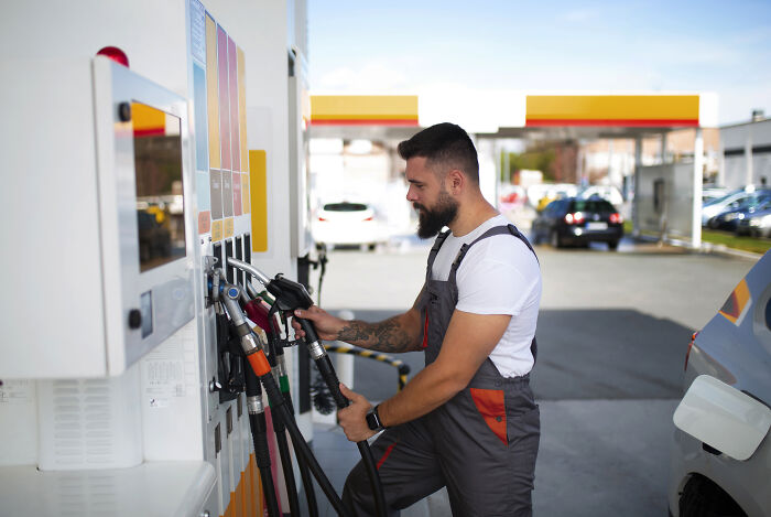 Man with beard at gas station pump, illustrating moments when people regretted speaking and wished to stay silent.