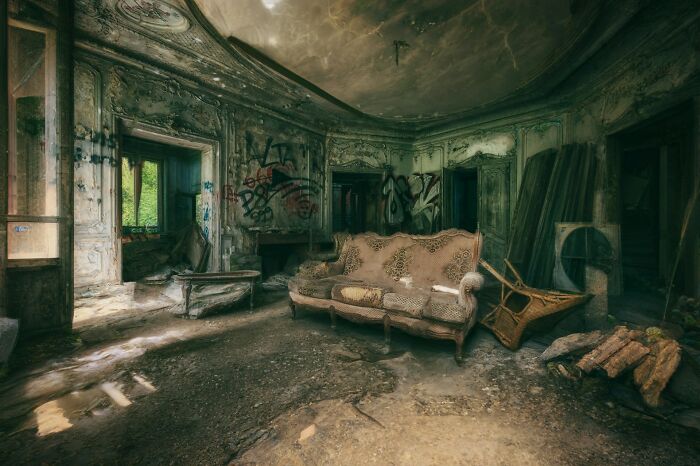 Abandoned room covered in graffiti with decayed furniture and debris, evoking terrifying moments for urban explorers.