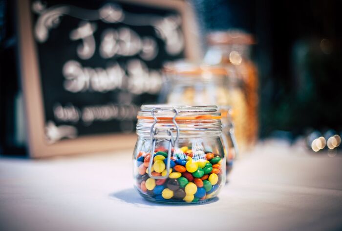 Glass jars filled with colorful candy on a table, illustrating bizarre true stories that sound unbelievable.