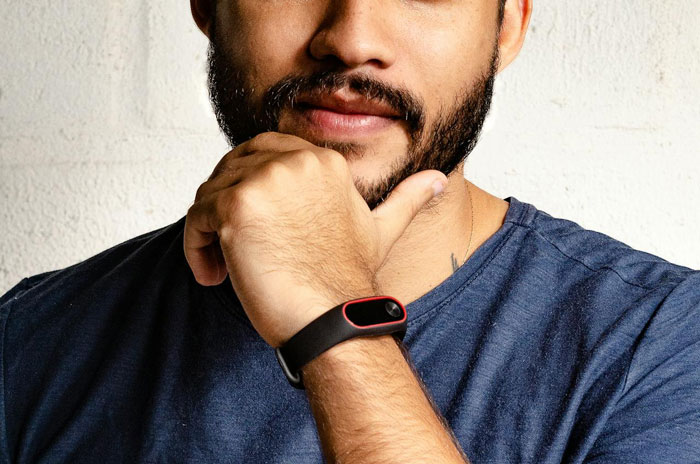 Man with beard and dark hair wearing a black wristband, looking thoughtful, depicting suspicion and concern about psychopath behavior. Man with beard and dark hair wearing a black wristband, looking thoughtful, depicting suspicion and concern about psychopath behavior.