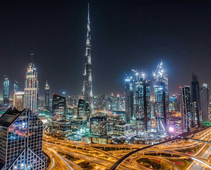 Dubai cityscape at night featuring illuminated highways and skyscrapers including Burj Khalifa, related to model horrific injuries comeback.