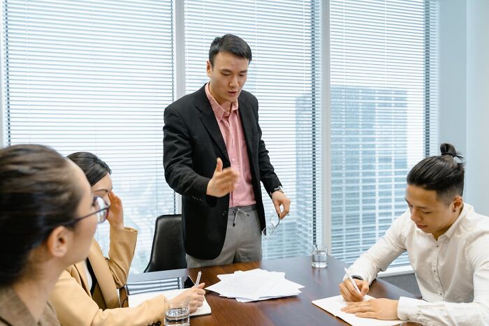 A business meeting with four people discussing ideas that sounded like a complete joke but were very serious.