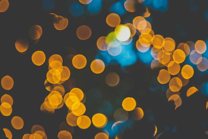 Blurred golden and blue bokeh lights creating an abstract background testing how sharp is your vision challenge.