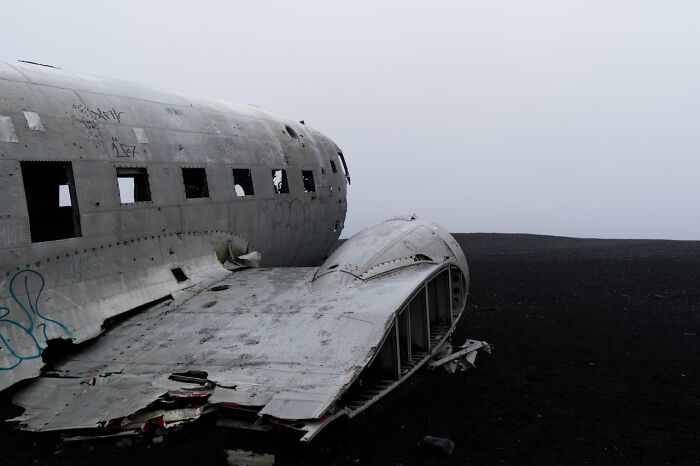 Wreckage of a crashed airplane in a desolate landscape, illustrating struggles medical staff face in ER emergencies.
