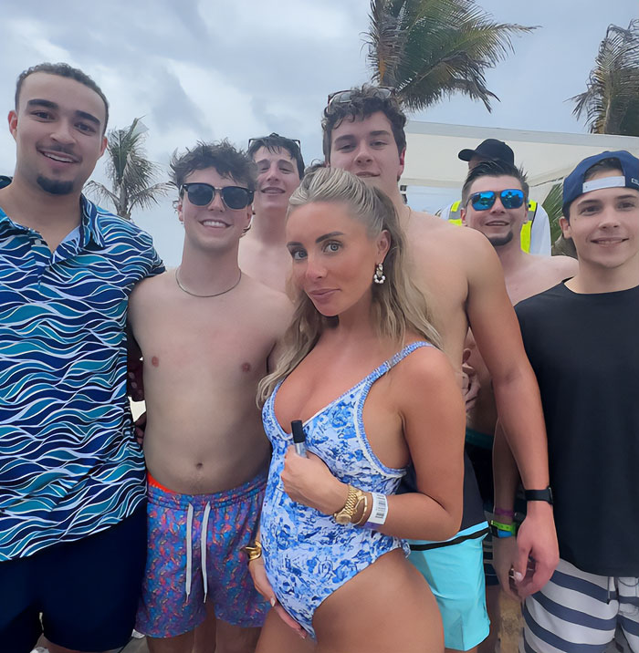 Group of young people posing outdoors with palm trees, related to Bonnie Blue criminally charged after disturbing public stunt in London.