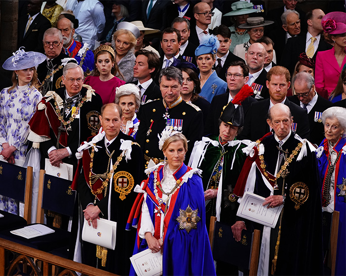 Senior royals attending a formal event, showcasing attire and expressions related to lip reader insights on Meghan Markle.