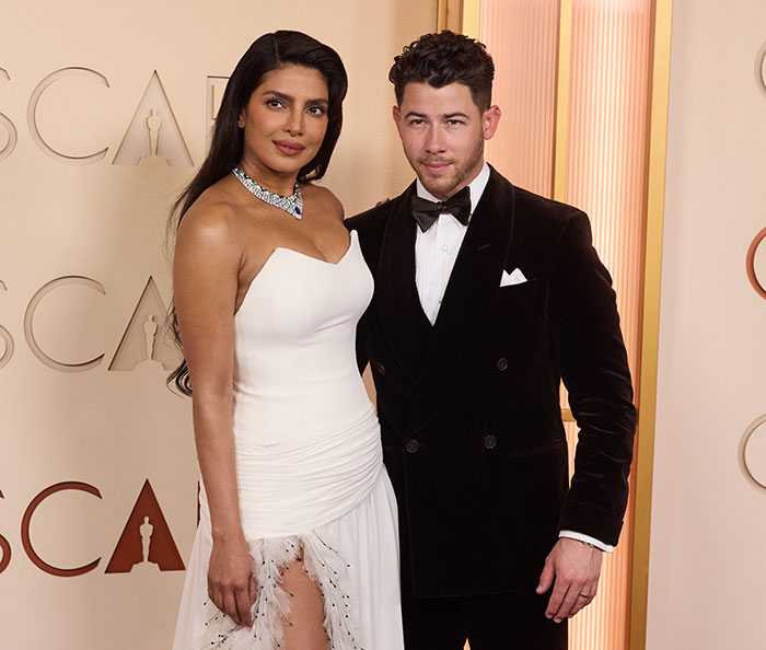 Actor and actress posing together on the red carpet at the Oscars event featuring cringe moments highlights.
