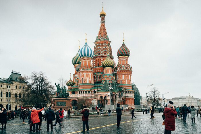 Crowds of tourists visiting iconic landmark Saint Basil’s Cathedral, a popular destination linked to many myths worldwide.