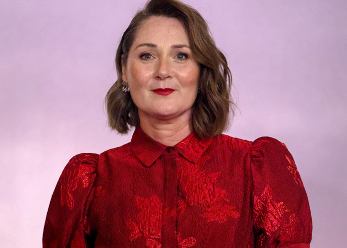 Ruth Gemmell wearing a red blouse, sharing emotions after filming an intimate sequence for Bridgerton.