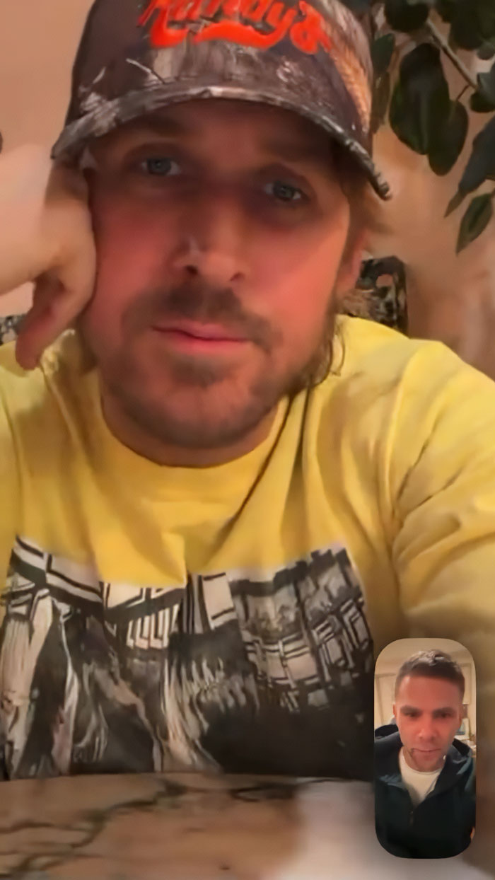 Ryan Gosling wearing a cap and yellow shirt during a casual video phone call with Mikey Day at home.