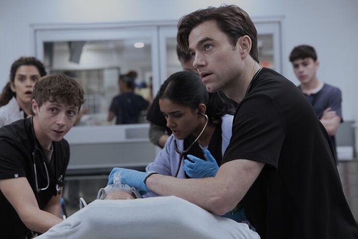 Doctors and medical staff attending to a patient in a hospital scene from The Pitt Season 2 Episode 13 preview.