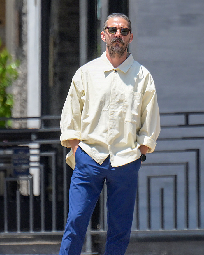 Shia LaBeouf wearing sunglasses and casual clothes, walking outdoors looking serious during Rome incident footage.
