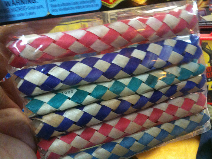 Colorful woven paper noise makers in a package, evoking nostalgic childhood memories and playful moments from the past.
