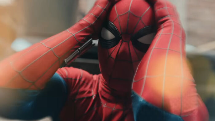 Spider-Man in costume holding his head, highlighting Peter Parker powers looking broken in Brand New Day trailer.
