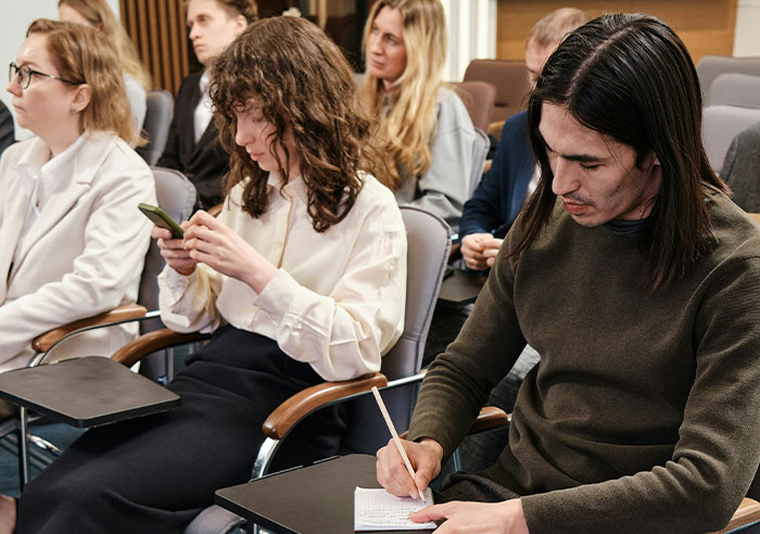 Young adults in a seminar, showing eye-opening moments that made people realize they were truly spoiled.