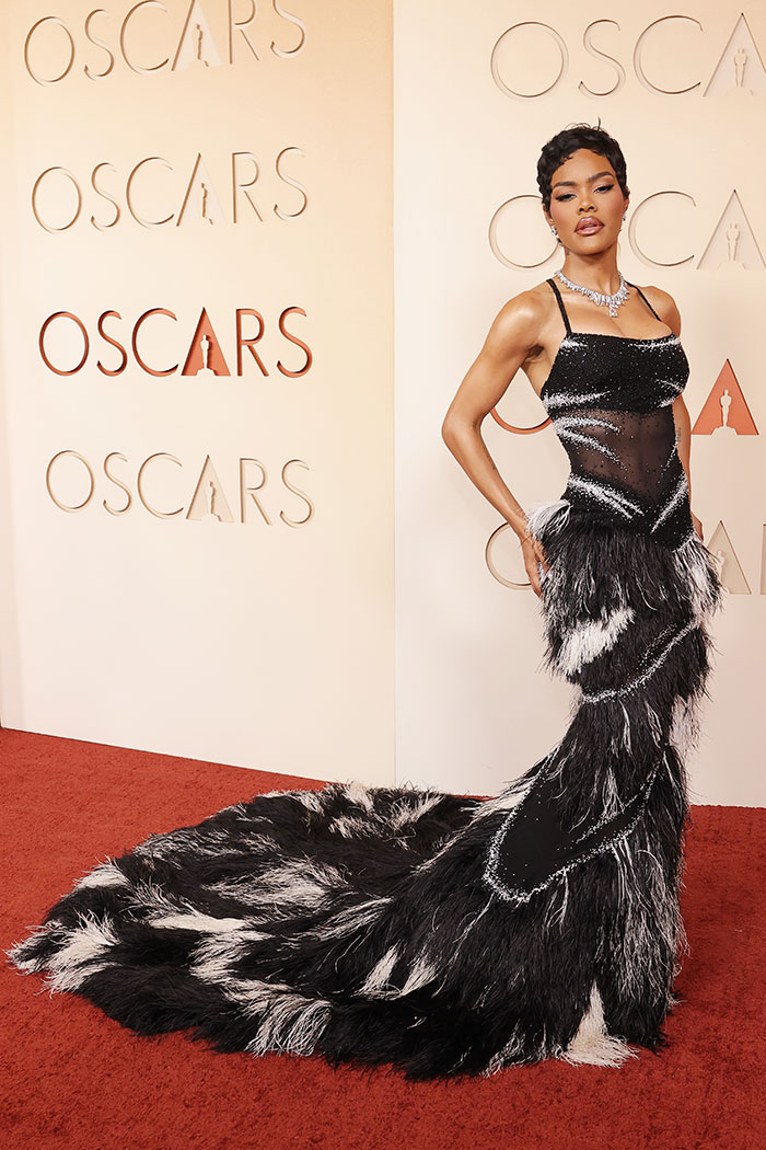 Model wearing an outrageous feathered black and white gown at the Oscars, showcasing disastrous looks from the 2026 event.