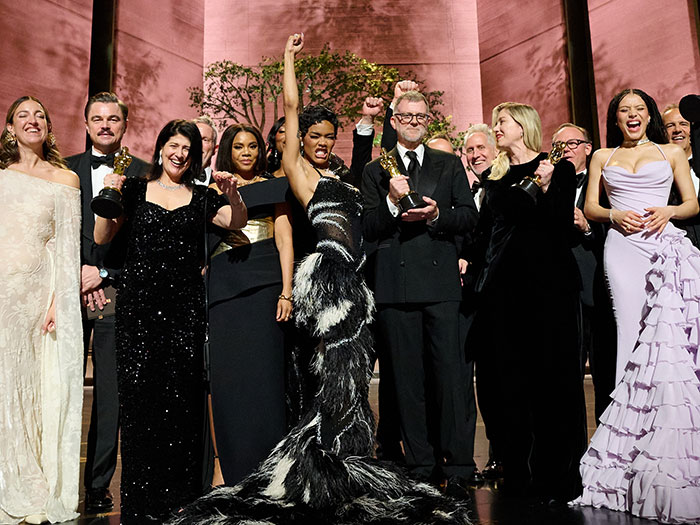 Group of diverse actors and filmmakers celebrating with Oscars at the 2026 Oscars including memorable cringe moments on stage.