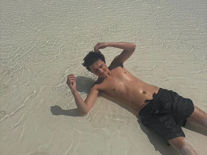 Timothée Chalamet lying shirtless in shallow beach water, sparking fan curiosity about his relationship with Kylie Jenner. Timothée Chalamet lying shirtless in shallow beach water, sparking fan curiosity about his relationship with Kylie Jenner.