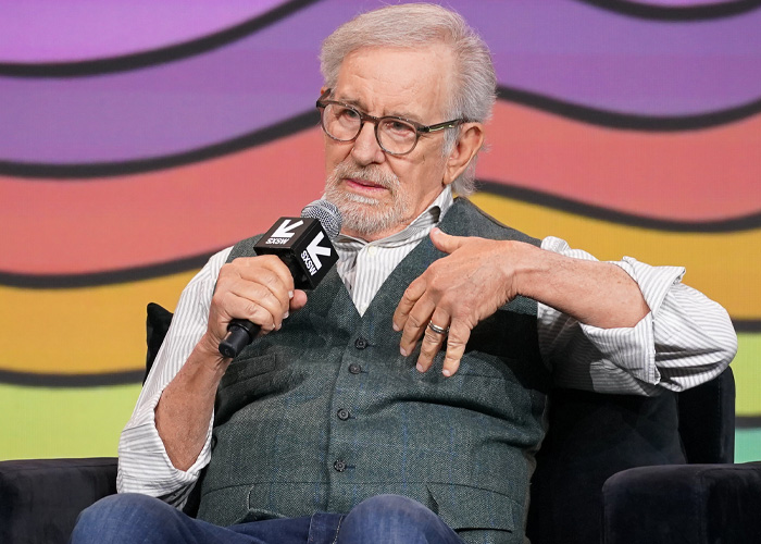 Steven Spielberg speaking into a microphone during SXSW panel, discussing Timoth&eacute;e Chalamet and film industry topics.