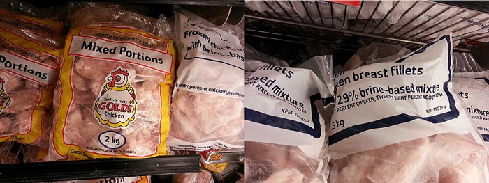 Frozen mixed chicken portions and breast fillets packaged in plastic bags on a supermarket freezer shelf.