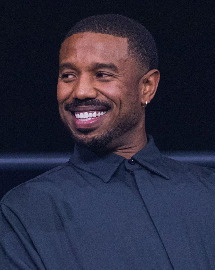 Smiling man with short hair and beard wearing a dark shirt, representing humans neurologically entering adulthood at 32 years.