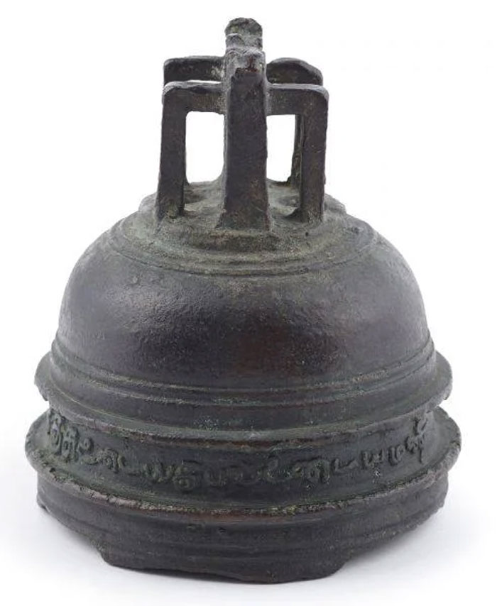Ancient metal bell with inscriptions, symbolizing the concept of humans neurologically entering adulthood at the age of 32.