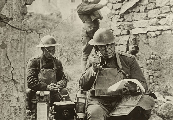 Soldiers in World War I setting up vintage communication equipment, illustrating rare one-in-a-million stories from history.