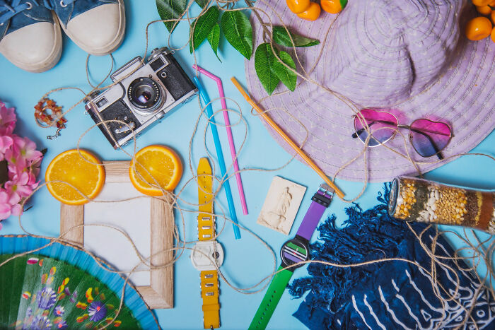 Assorted colorful family items arranged on a blue background representing unconventional family traditions and memories.