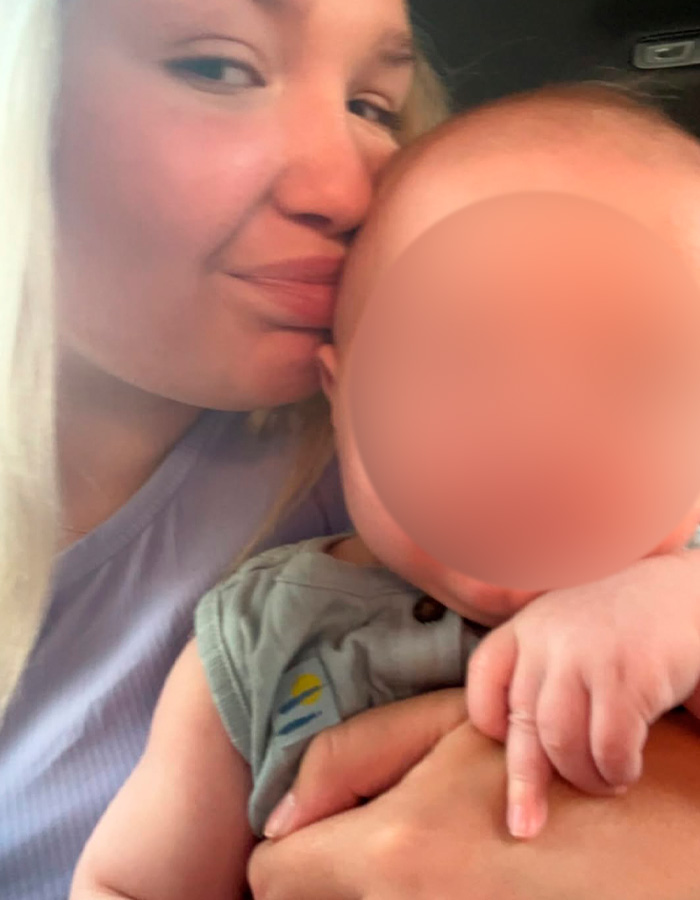 Young mother holding baby closely, highlighting the controversial case of a 15-year-old pregnant by a 12-year-old update.