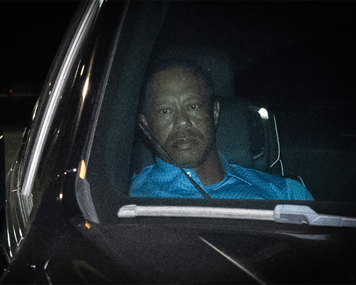 Tiger Woods sitting in a car at night, capturing a moment linked to Vanessa Trump and a DUI arrest.