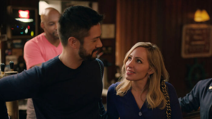 Two characters from Virgin River share a moment in a dimly lit bar, highlighting Mike Valenzuela and Marco Grazzini&rsquo;s roles.