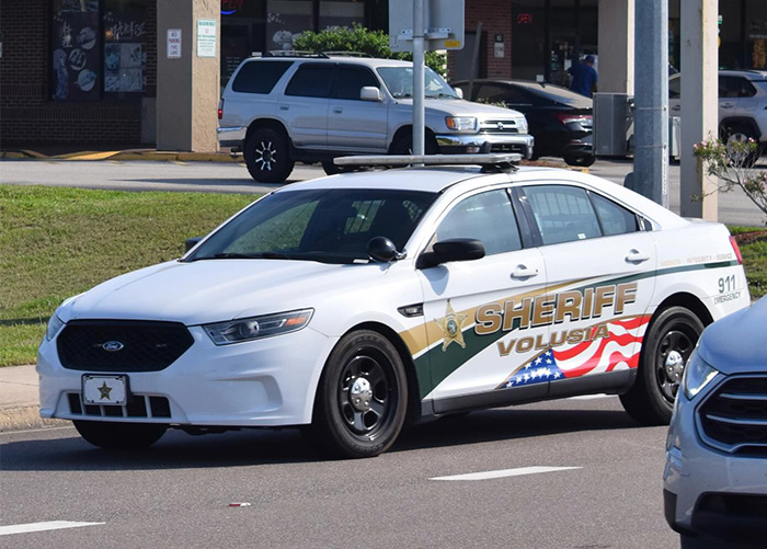 White Volusia Sheriff patrol car parked on a city street related to mom allegedly allowing boyfriend to harm her young son case