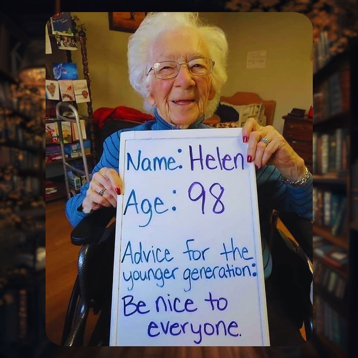Elderly woman holding uplifting advice sign, highlighting kind messages as part of good and uplifting posts in the world.