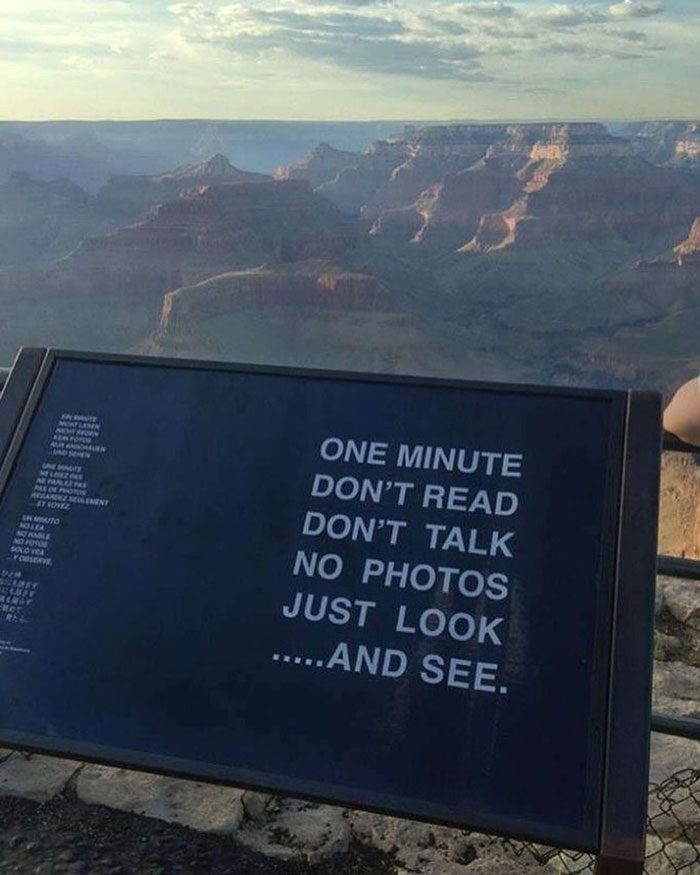 Scenic view with an inspirational sign encouraging a moment of silence to see something good in the world.