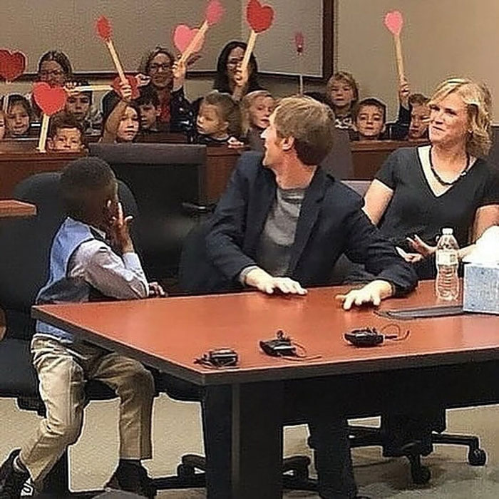 Children holding heart paddles in a positive setting, sharing uplifting moments that show kindness and hope in the world.