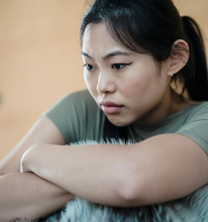 Woman feeling emotional and reflective after congratulating boyfriend and his pregnant mistress in front of coworkers.