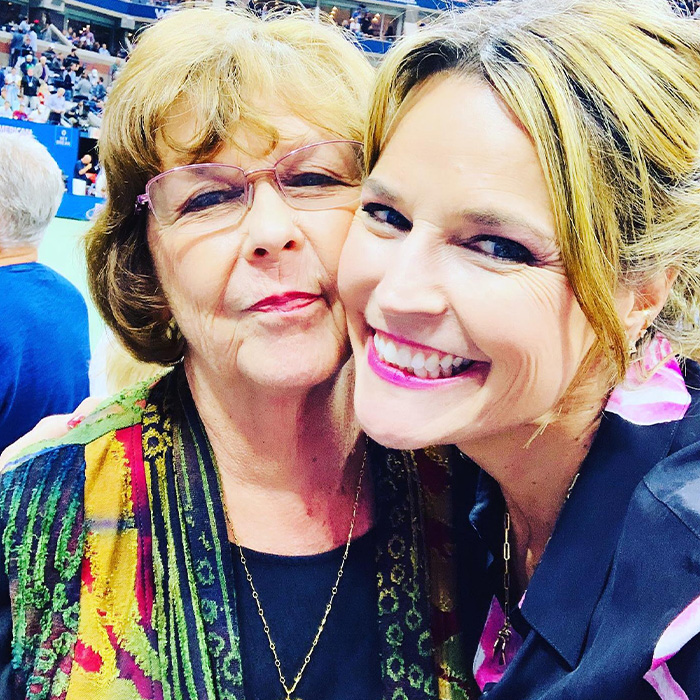 Two women smiling together at a crowded event, relating to body of woman found near Phoenix canal and Nancy Guthrie case.