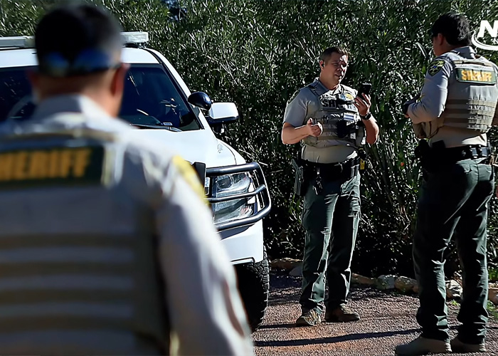 Sheriff officers standing near a white vehicle investigating the body of woman found near Phoenix canal case.