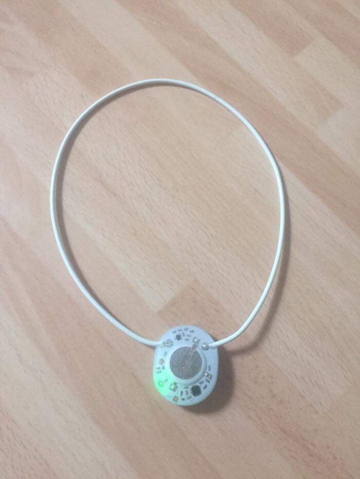 Small electronic device with circuit board and wire on wooden surface, mystery object solved by internet users.