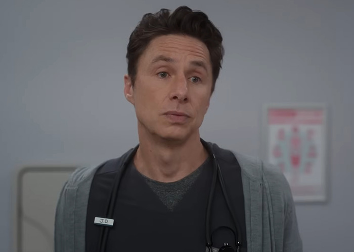 Zach Braff wearing a medical outfit with stethoscope, looking thoughtful in a clinical setting.