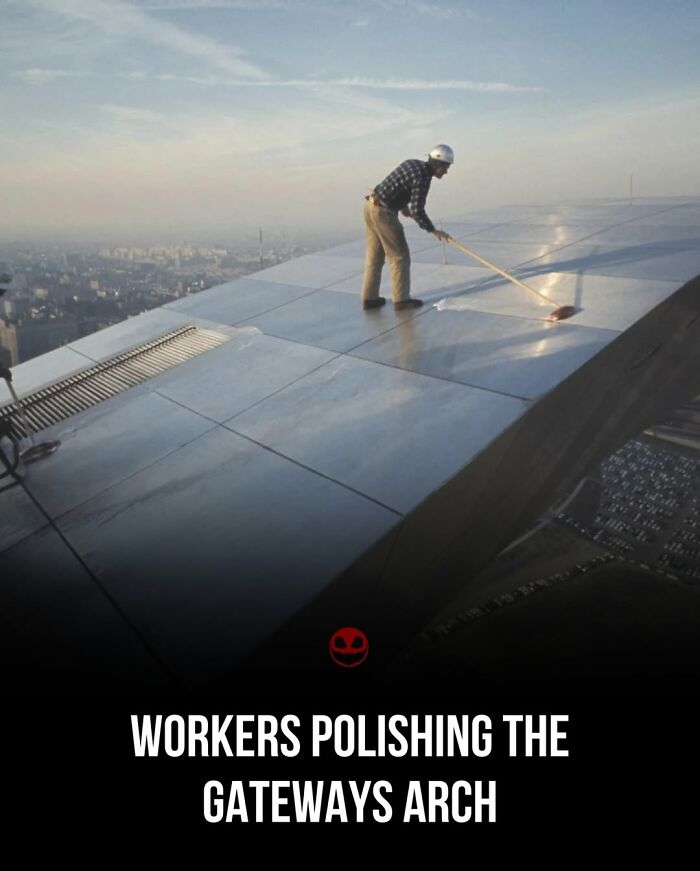 Worker polishing the shiny surface of the Gateway Arch, showcasing a weird and odd fact in a high place.