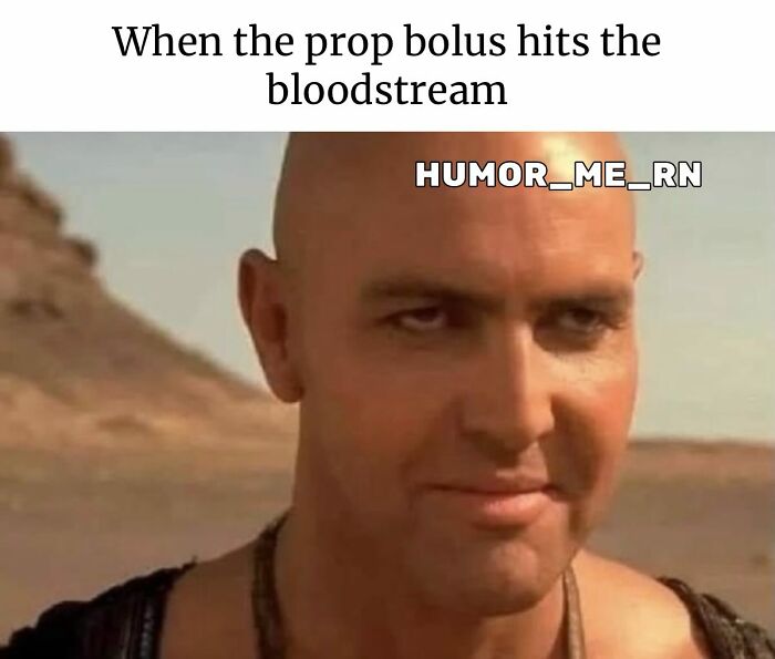 Man with a shaved head smirking in a desert scene, healthcare meme illustrating prop bolus effect humor.