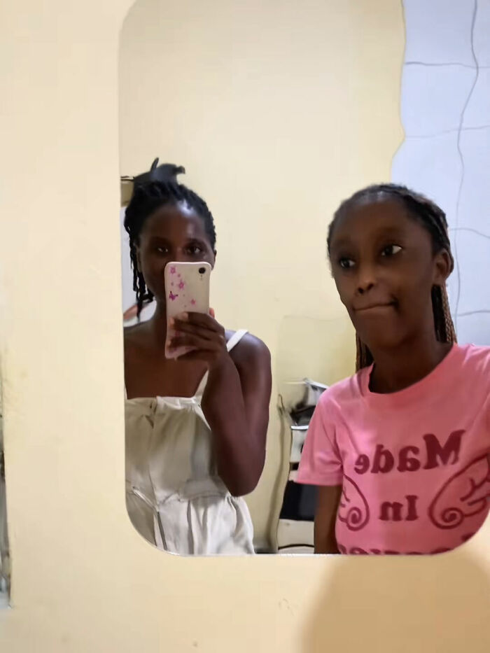 Two women taking a mirror selfie indoors, capturing a moment related to learning a hilarious lesson from Temu orders.