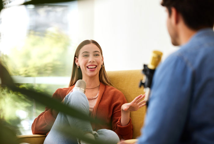 Young woman speaking confidently during a podcast, illustrating unhinged and wild ways women make men feel uncomfortable.