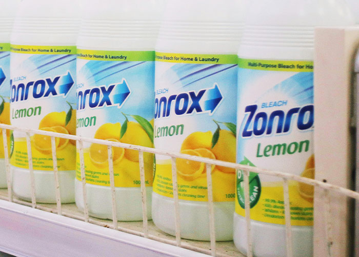 Bottles of bleach with lemon scent displayed on a store shelf, highlighting things more dangerous than they seem.