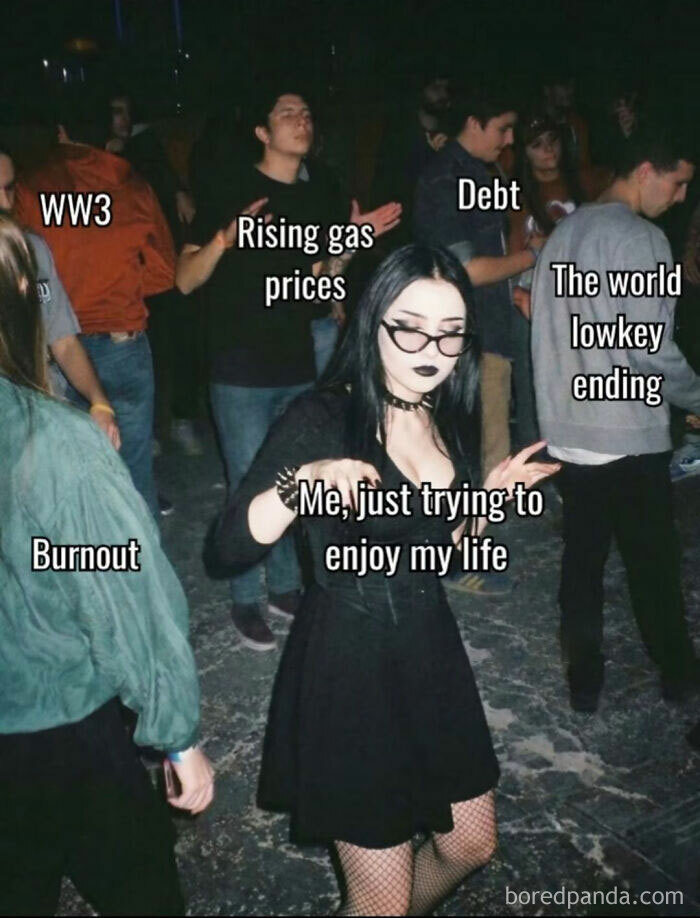 Young woman in goth attire dancing at a party, surrounded by text labels of stressors, reflecting funny memes for relaxing evening.