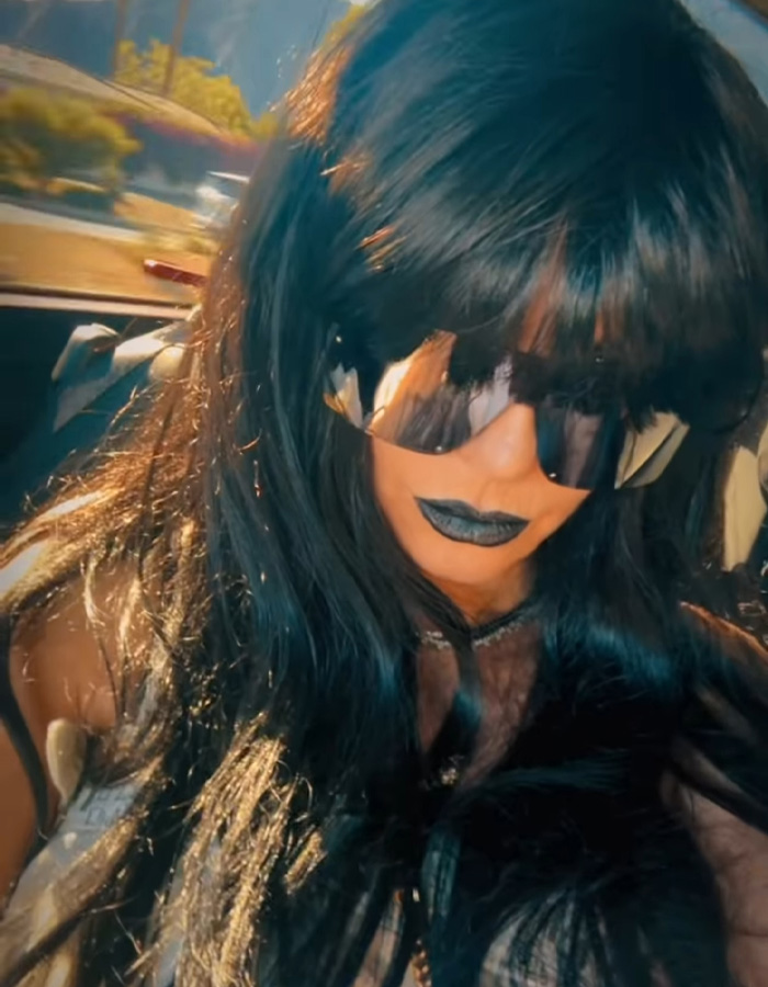 Heidi Klum with black lipstick, long dark hair, and sunglasses showcasing her unrecognizable Coachella 2026 look.