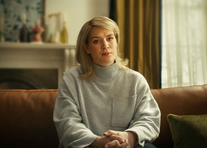 Devastated bride-to-be seated on couch, appearing emotional and reflective before exposing fianc&eacute;'s horrific crimes.